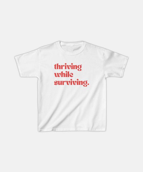 "THRIVING WHILE SURVIVING." BABY TEE